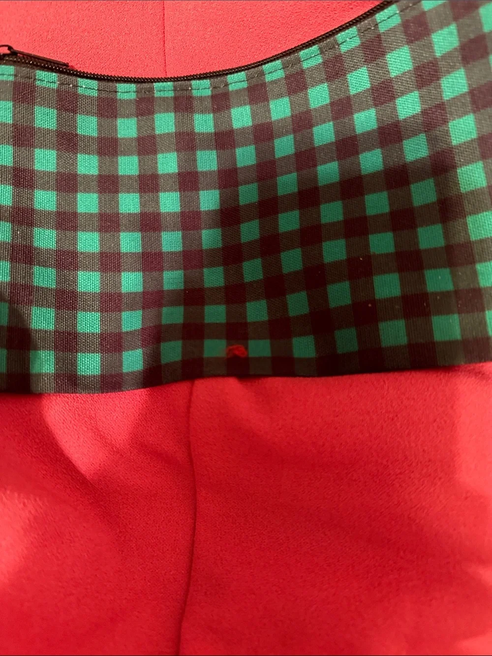 Green and black plaid makeup bag filled